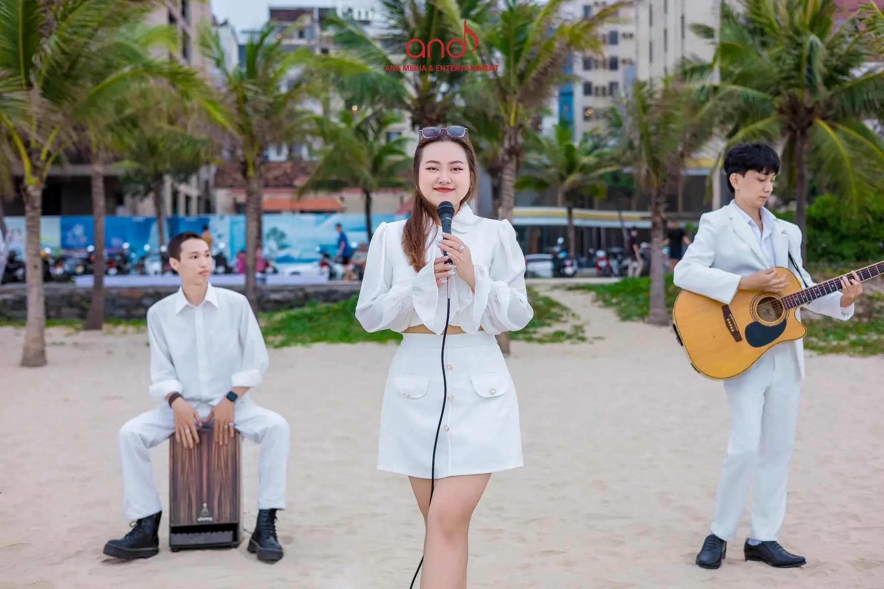 Acoustic trio with cajon, vocals and guitar on the beach