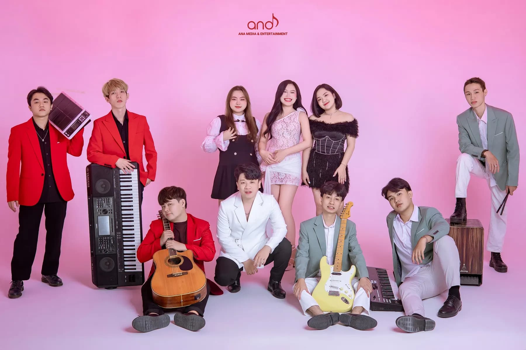 The full Ana Band roster in a pink studio
