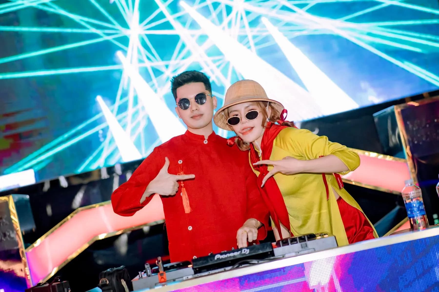 Two DJs at the decks under laser lights