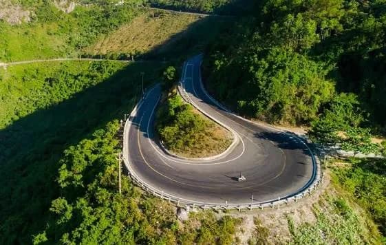 Hairpin bend on the Hai Van Pass through green forest