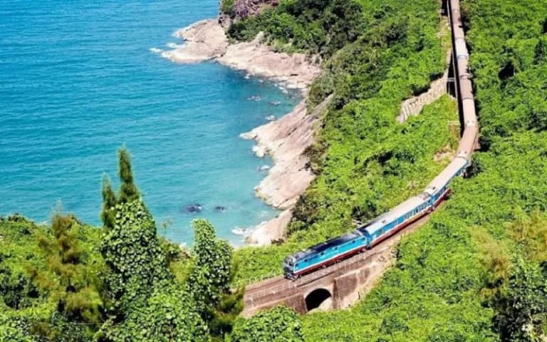 Train winding along the cliffs above the sea at Hai Van