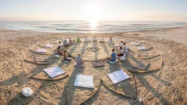 Meditation circle drawn in the sand on a beach at sunrise