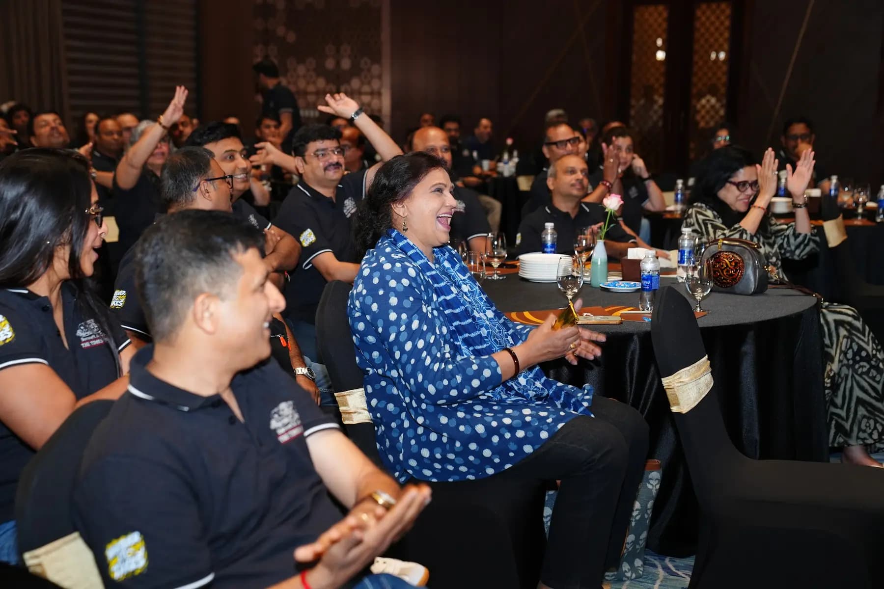 Guests cheering at their tables during the programme