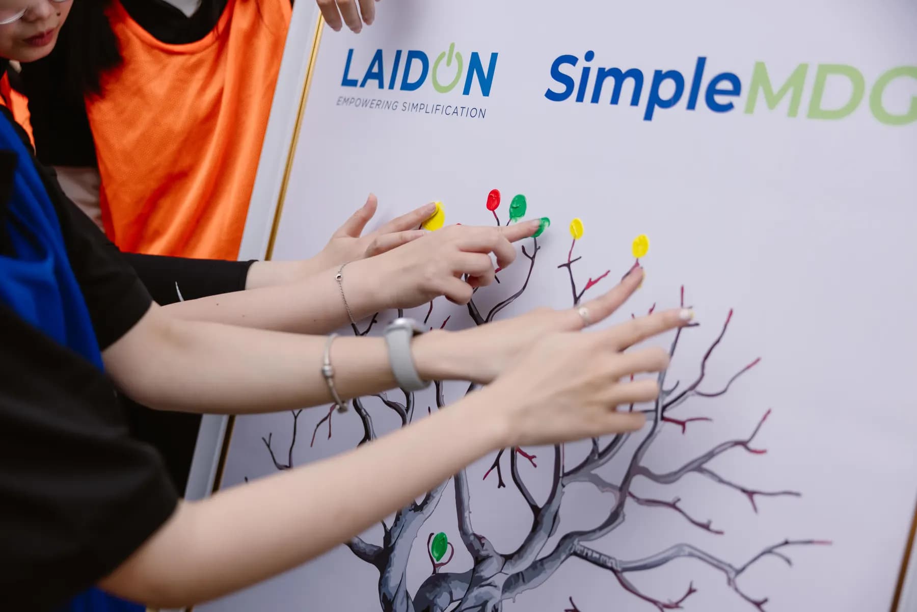 Guests adding coloured fingerprints to the Laidon and SimpleMDG tree board