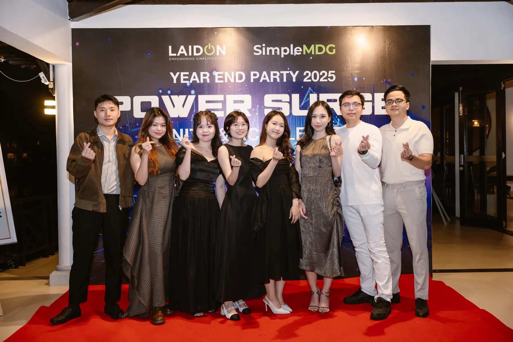 Guests in evening wear posing on the red carpet