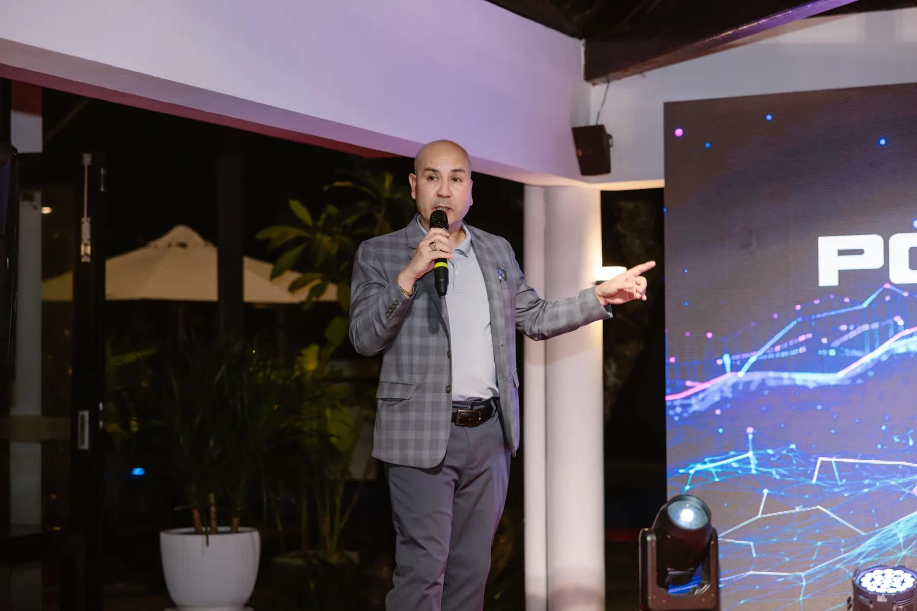 Company leader speaking beside the LED screen
