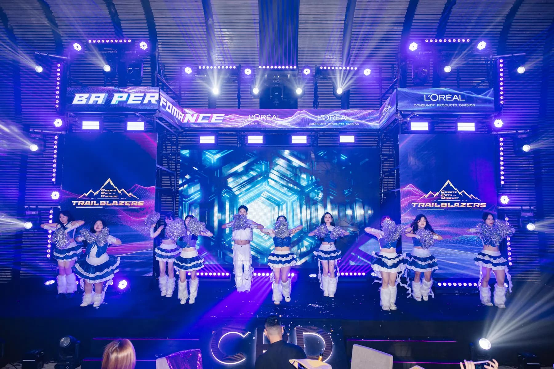 Team in blue and white costumes performing in the BA Performance contest
