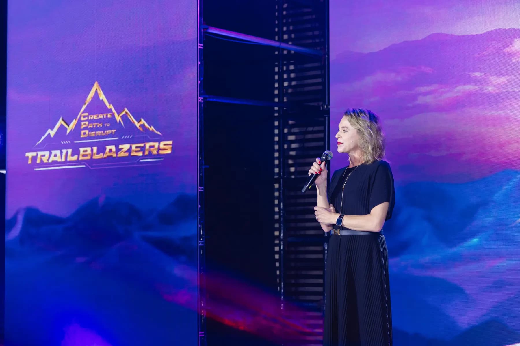 Speaker addressing the room beside the Trailblazers key visual