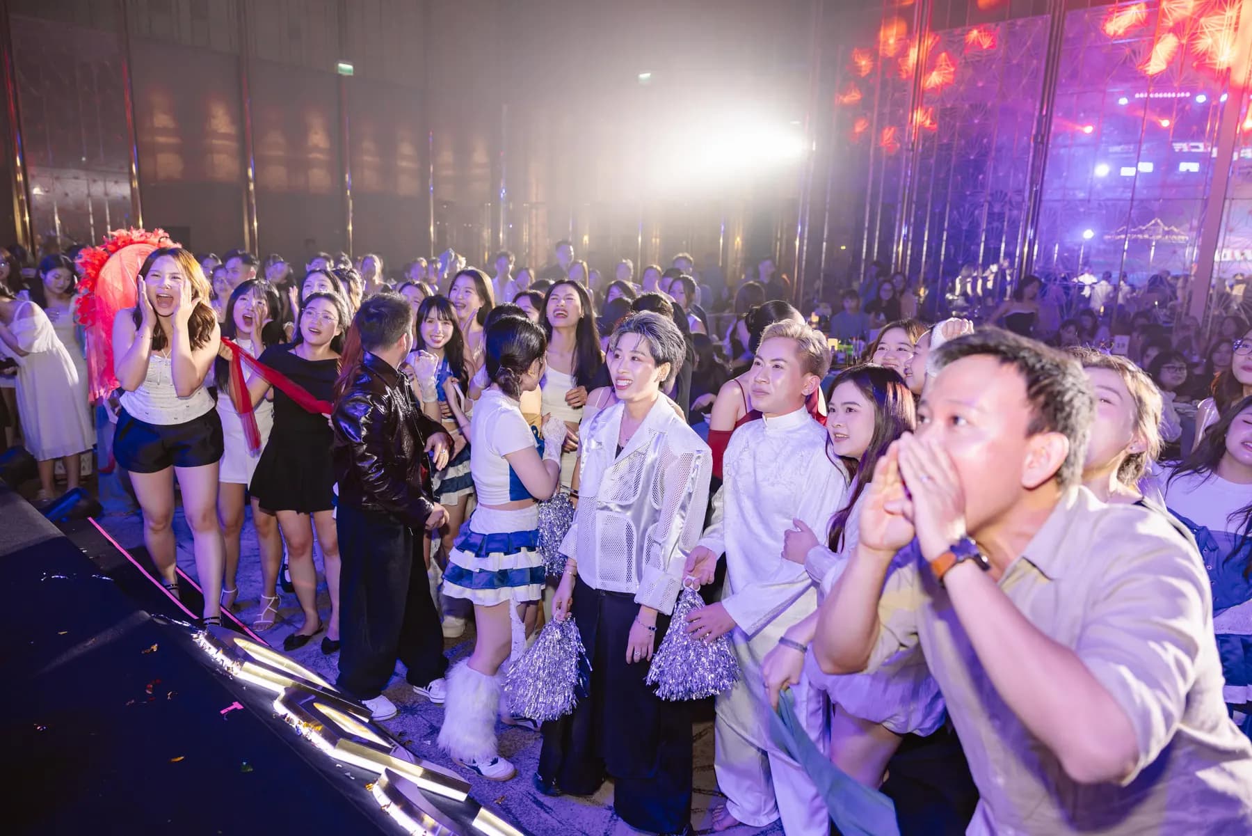 Guests cheering in front of the stage at the end of the gala