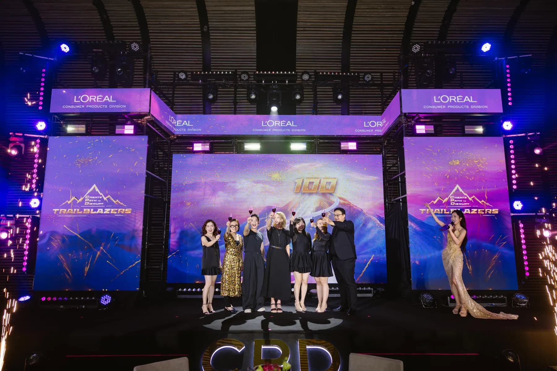 Leaders on stage between cold sparkler fountains