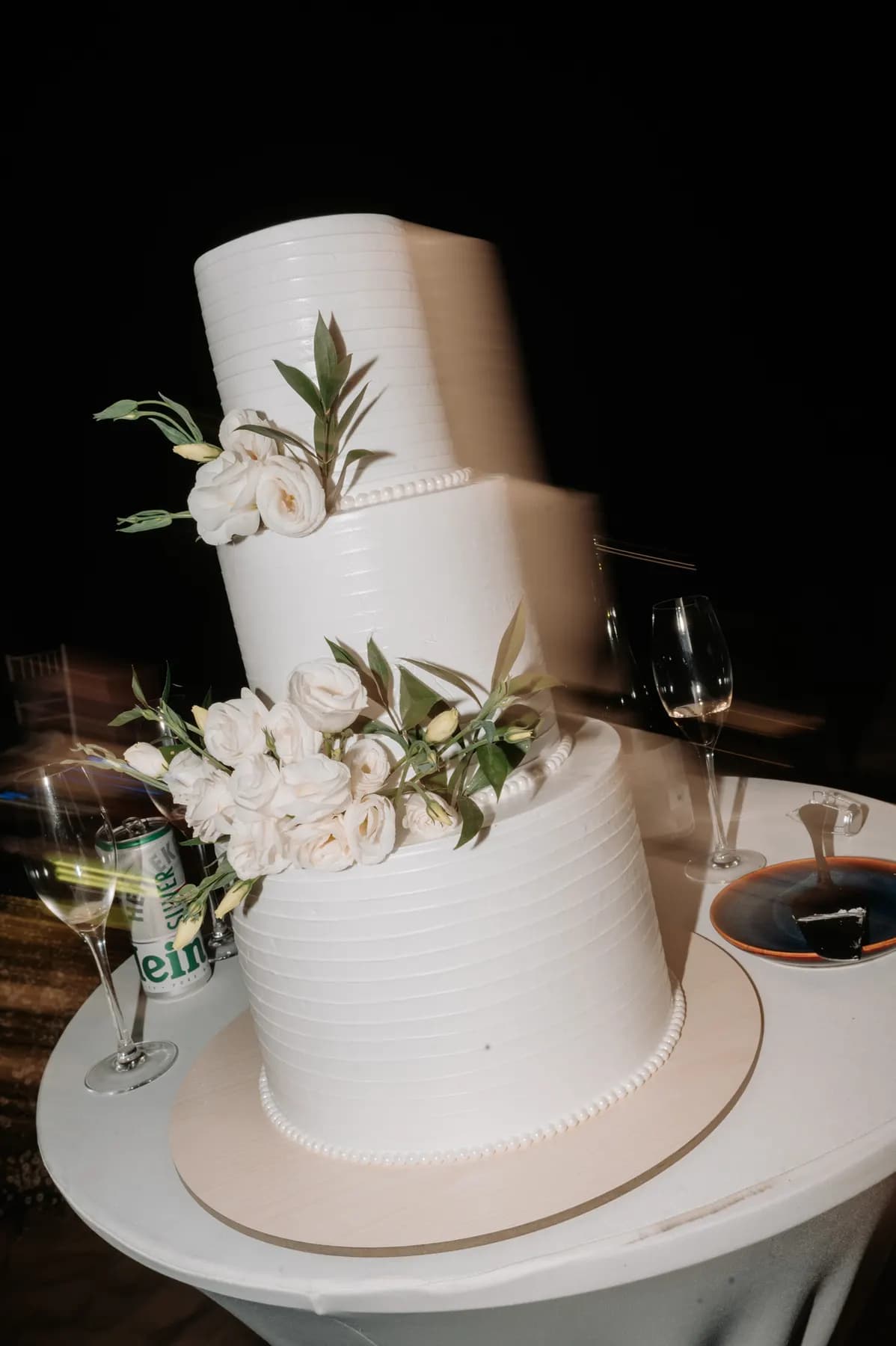 Three-tier white wedding cake with flowers