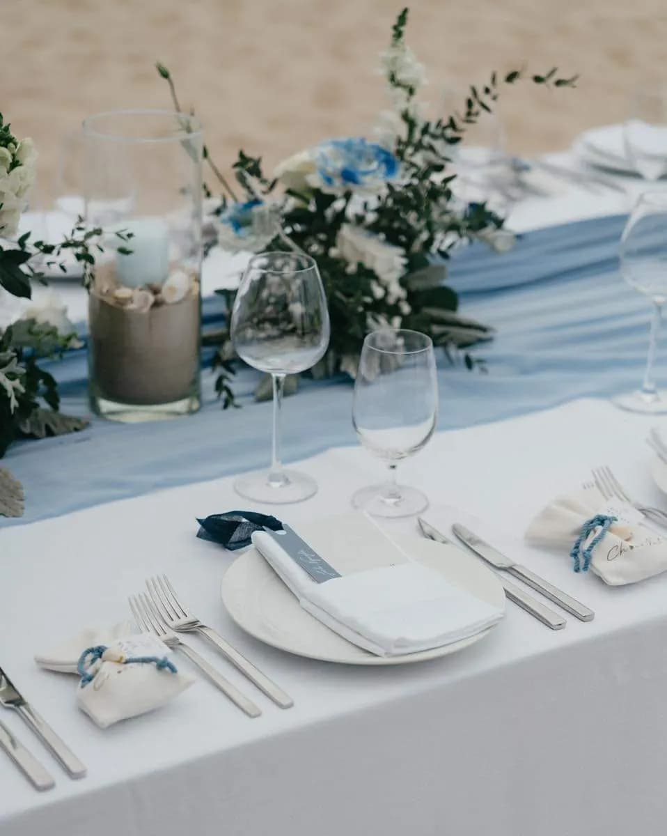 Place setting with a blue runner and greenery